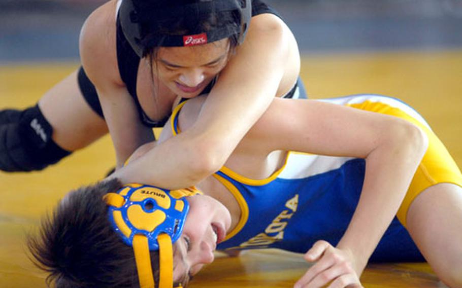 YeJeen Nam of Osan American gets the upper hand on Yokota&#39;s Ed Peterson during Thursday&#39;s 101-pound bout. The advantage was short-lived; Peterson decisioned Nam 2-0 (2-1, 5-1).