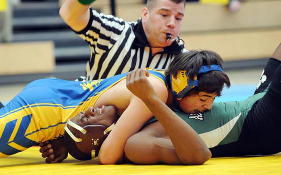 In a 145-pound match at the DODDS-Europe wrestling championships in Wiesbaden, Germany, Ansbach&#39;s Daniel Mariscal pins AFNORTH&#39;s Tizhaun Carroll, as referee Chad Malley gets ready to hit the mat. Three hundred and thirty-six matches were wrestled Friday, with second-round action scheduled to start at 9 a.m. Saturday. The title matches are set to start at 3:40 p.m. at the Wiesbaden Air Field fitness center.