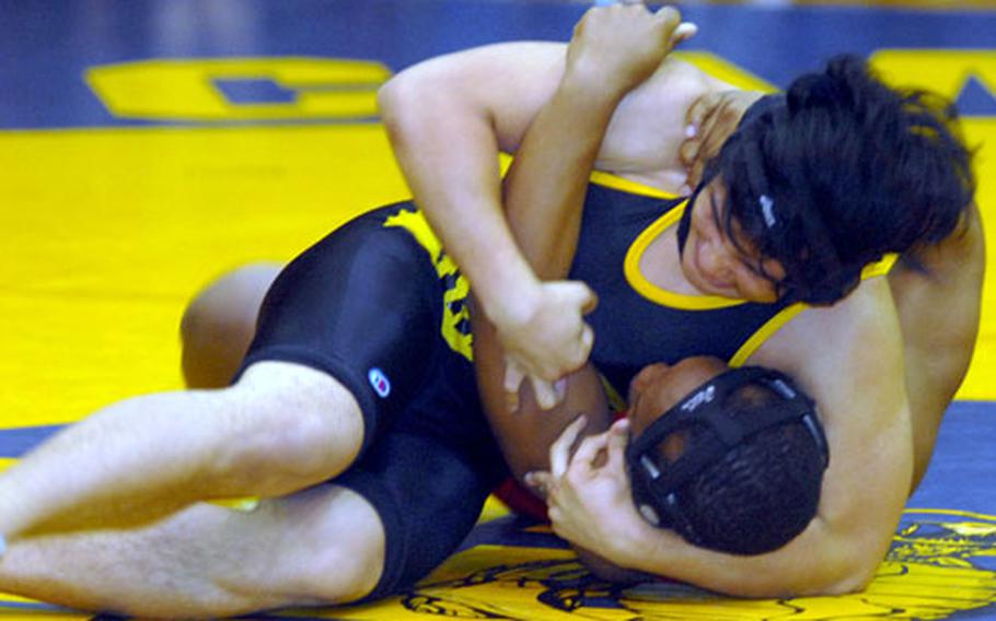 Kadena&#39;s Cody Reyes applies a head-in-arm hold on Nile C. Kinnick&#39;s David Ford during Saturday&#39;s 158-pound bout. Reyes pinned Ford in 41 seconds, clinching the dual meet for Kadena.