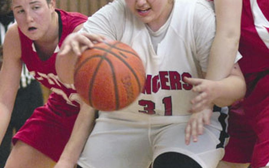 Lisa McBride of Lakenheath dribbles past Barbara Burriss, left, and Karah Helm of Kaiserslautern during a battle of Division I foes on Jan. 29. Lakenheath’s victory in that game earned it the top seed in the Division I tournament, which begins Wednesday in Mannheim, Germany. Kaiserslautern is the No. 2 seed.