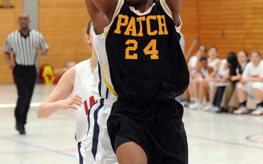 Patch&#39;s Janelle Loney, right, gets past Lakenheath&#39;s Keyah Gunter for a basket, as fifth-seeded Patch beat the top-seeded Lady Lancers 46-34 in opening- day Division I action at the DODDS-Europe finals in Mannheim, Germany, on Wednesday.