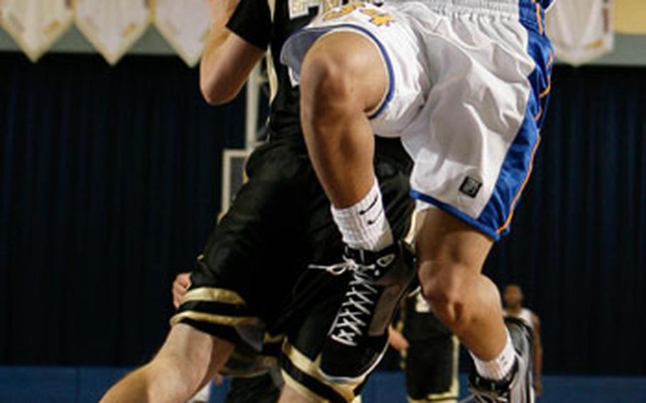 Gary Cashman/Special to Stars and Stripes Yokota’s Tajh Kirby drives to the basket against American School In Japan’s Peter Forster during Thursday’s quarterfinal game in the Class AA tournament at Yokota High School, Yokota Air Base, Japan. Host Yokota rallied past ASIJ 58-52 and into Friday’s semifinal game against Guam’s Simon Sanchez Sharks.