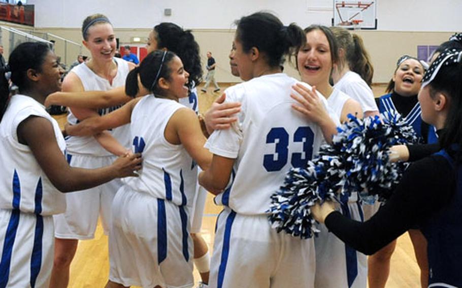 The Rota Lady Admirals celebrate their 32-13 victory over Brussels in the Division IV championship game.