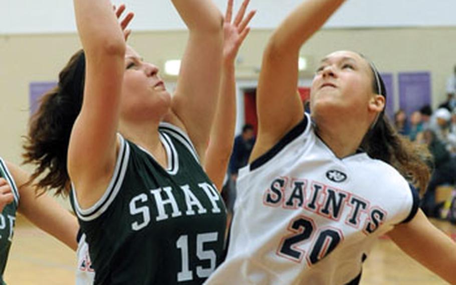 SHAPE's Liene Bauska attempts a shot over Aviano's Gabby Aumack in the Division II title game of the DOODS-Europe basketball championships in Mannheim, Germany, on Saturday. Aviano took the crown with a 50-39 victory.