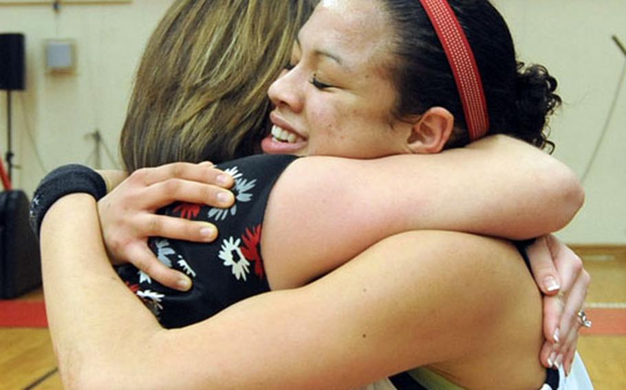Aviano&#39;s Alyssa Lane, right, gets a victory hug from coach Shari McGuire after the Lady Saints beat SHAPE 50-39.