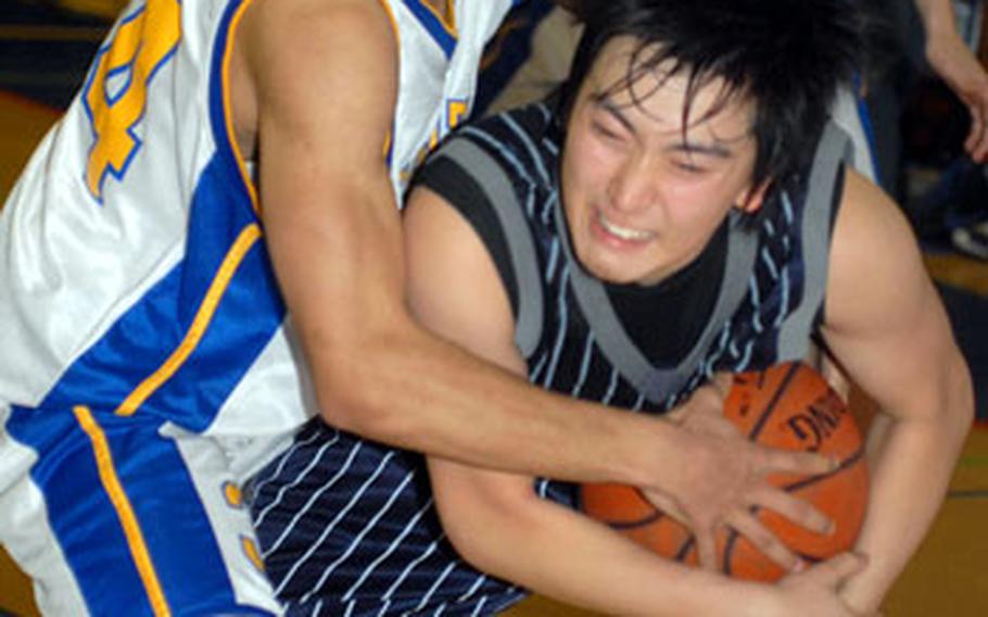 Hayato Nishi, right, of St. Mary&#39;s International protects the ball after he steals it from Yokota&#39;s Tajh Kirby during Saturday&#39;s final. St. Mary&#39;s edged Yokota 35-33 for its third Class AA title since 2001.