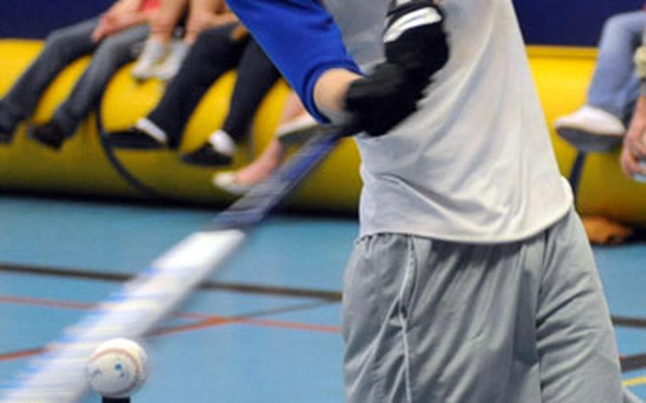 Matt McDonald connects during batting practice in the Ramstein High School gym on Friday. The Royals are getting ready for the inaugural DODDS high school baseball season. Wet, cold German weather kept the team indoors for practice.