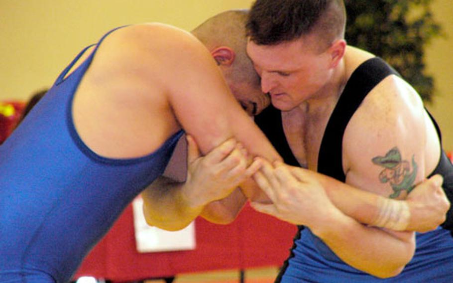 William Taylor, right, ties up with Jared Chumley in their 185-pound match at the U.S. Forces Europe Greco-Roman wrestling championships Saturday at Miesau, Germany. Taylor prevailed 8-5 in the battle between two Kaiserslautern-based wrestlers.