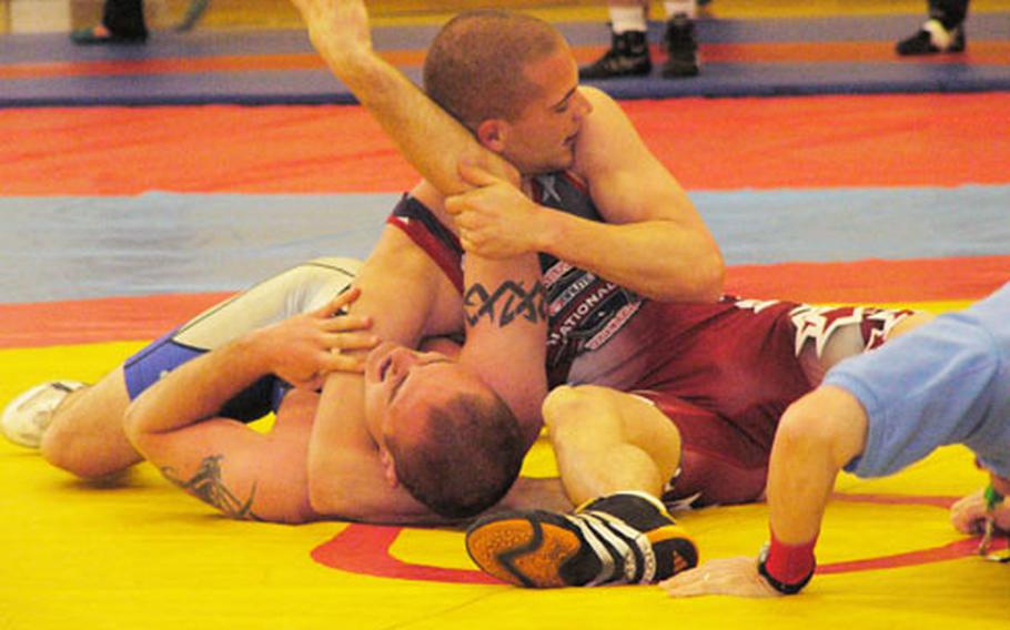 Kaiserslautern’s Nicholas McDonald locks in the pin at 1:17 of his 163-pound match against Ramstein’s Travis Rolstad during Sunday’s U.S. Forces Europe freestyle wrestling championships.