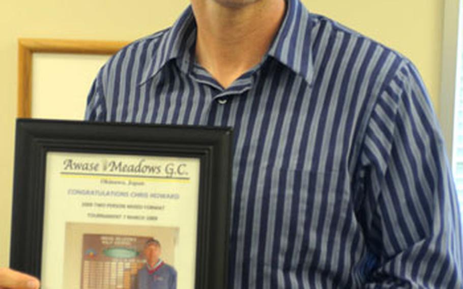 Chris Howard displays a photograph given to him by Awase Meadows Golf Course officials after Howard scored a rare two holes in one during the same golf round on Saturday.