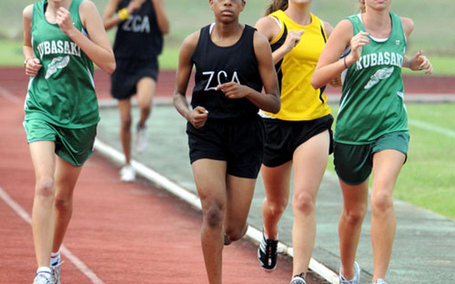 Kubasaki&#39;s Jessica Powell, right, leads the pack as teammate Amanda Henderson, Zion Christian Academy&#39;s Teauna Baker and Kadena&#39;s Britni Dougherty give chase during the two-mile run. Powell won the event in 13 minutes, 32 seconds.