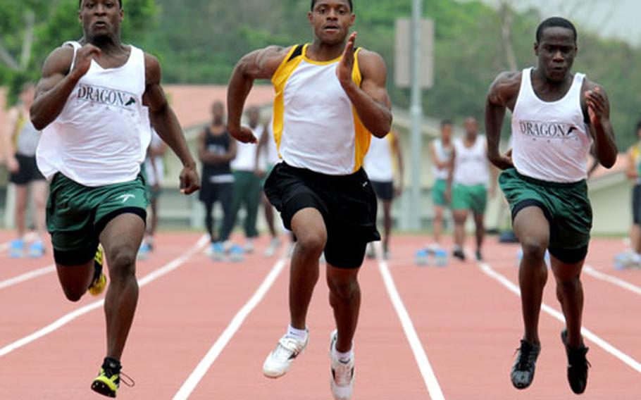 From left, Kubasaki&#39;s Marquette Warren, Kadena&#39;s Brandon Harris and Kubasaki&#39;s Lewis Finney pound for home in the 100-meter dash during Saturday&#39;s Okinawa Activities Council track and field meet at Kadena Air Base. Harris won in 11.37 seconds, Warren was second in 11.43 and Finney fourth in 11.71.