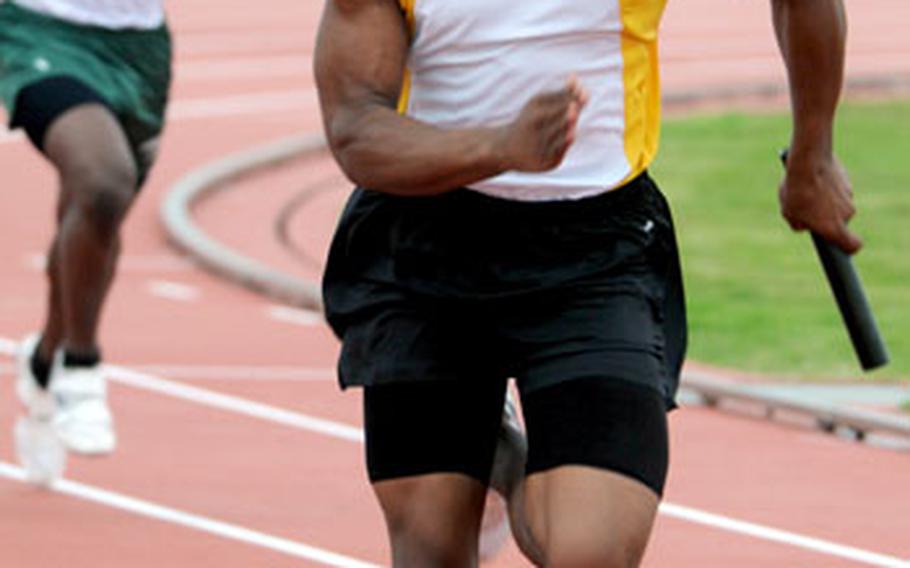 Kadena senior Brandon Harris runs the anchor leg of the 400 relay and leaves Kubasaki&#39;s Marquette Warren in his wake during Saturday&#39;s meet at Kadena. Harris and Kadena won the event in 45.41 seconds; Kubasaki was second in 46.84.