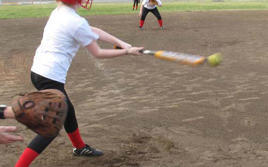 Nile C. Kinnick Red Devils pitcher Cheyenne Tullos connects during Tuesday&#39;s practice at Field 3, Berkey Field Complex, Yokosuka Naval Base, Japan. The Red Devils are 18-0 since the transition from slowpitch to fastpitch and are aiming for their second straight DODDS-Japan girls softball league and tournament titles. Tullos is 5-0 on the season.