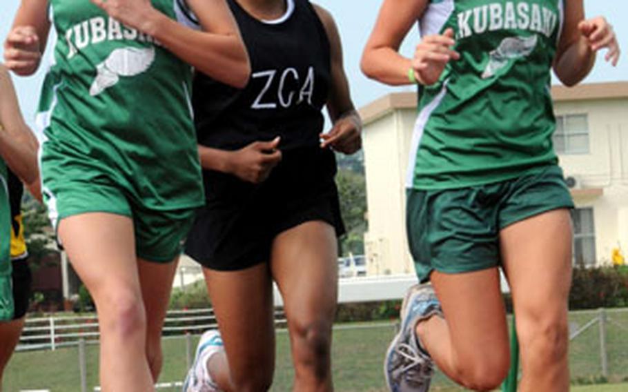 Kubasaki&#39;s Abbi Wall, left, and Jessica Powell run at the head of the pack just ahead of Teauna Baker of Zion Christian Academy during Thursday&#39;s two-mile run in the third Okinawa Activities Council track and field meet of the season at Camp Foster, Okinawa. Powell suffered her first defeat of the season as Baker, a sophomore and the reigning island champion, stormed past Powell in the home stretch. Baker won in 13 minutes, 0.93 seconds; Powell was second in 13:02.37.