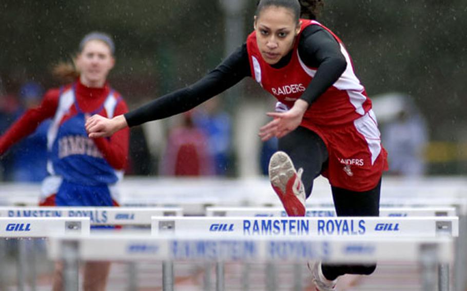 Kaiserlslautern senior Shalisa Baldwin races to victory in the girls 100-meter hurdles Saturday at Ramstein. Coaches cut the meet short due to heavy rain and hail.