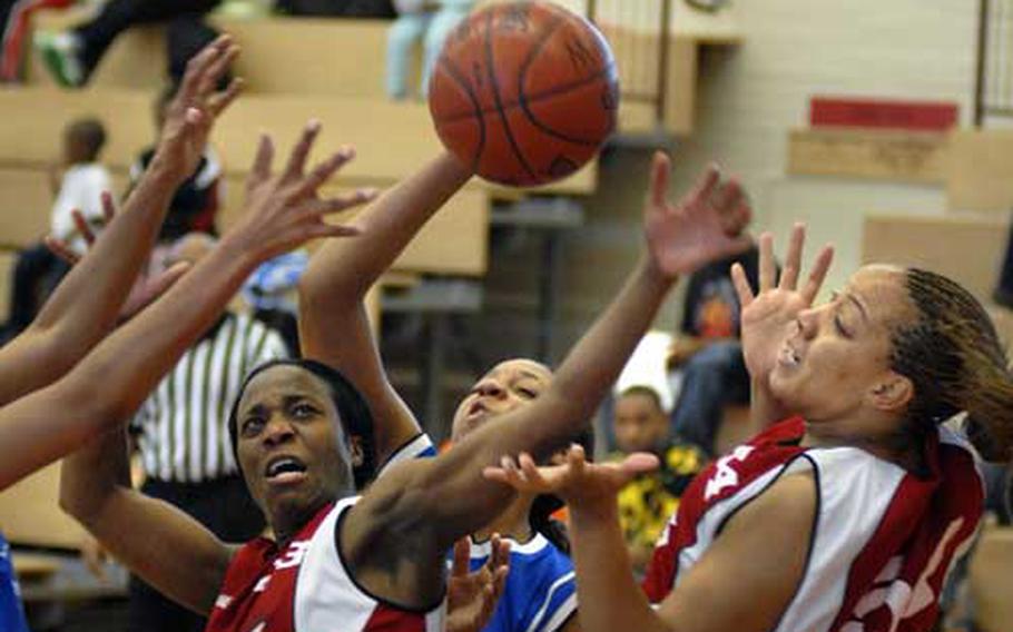 Lamanda Morant, center, and Angie Fields, right, of Mannheim battle for possession Sunday during their championship game against Heidleberg at Mannheim&#39;s sports arena. Mannheim beat out Heidelberg 45-35 clinching the women&#39;s U.S. Army Europe title.