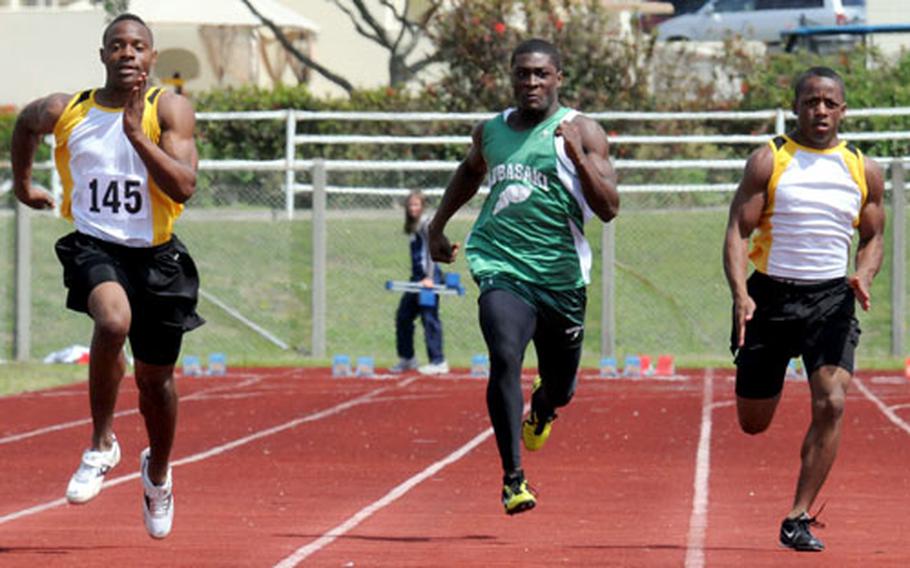 Kadena&#39;s Brandon Harris, left, and Shariff Coleman flank Kubasaki&#39;s Marquette Warren during Saturday&#39;s boys 100-meter dash in the 7th Alva W. "Mike" Petty Memorial Track and Field Meet at Camp Foster, Okinawa. Harris won the event in 11.64 seconds; Coleman was second with 11.86. Warren finished eighth in 12.08.