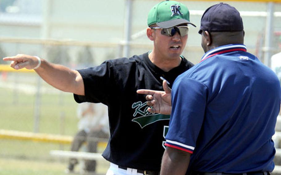 Kubasaki Dragons baseball coach Randy Toor argues his point with home plate umpire Gerald Sharber during Saturday&#39;s Game 2.