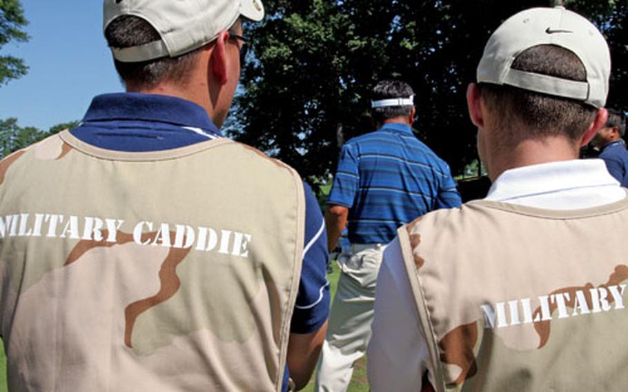 Guest "military caddies" from the Washington region signed up for a chance to loop for the pros. These soldiers from the Arlington Hill National Guard bureau headquarters are waiting for K. J. Choi to tee it up.