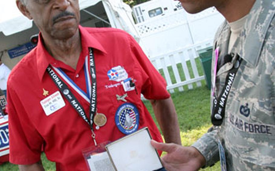 Sgt Dwight Hawkins, of San Diego, meets Tuskeegee Airman Ezra M. Hill. Hill, who travels the country promoting the history of the group, said Tiger Woods&#39; mother asked him at Augusta to come to Washington this summer for her son&#39;s tournament, which celebrates the U.S. military over July 4th weekend.
