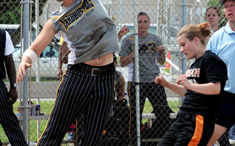 Catcher Tiffani Carritt of Yard Busters of Okinawa has the ball sail over her head as Lisa Stiger of Yongsan Garrison, South Korea, scores during Saturday&#39;s double-elimination championship bracket game. Yongsan beat Yard Busters 12-6.