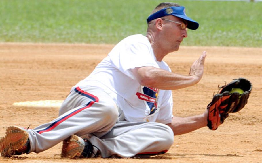 Former All-Marine pitcher Richie Krause of American Legion of Okinawa snags a hard grounder against Camp Humphreys of South Korea during Sunday&#39;s men&#39;s championship game in the 2009 Firecracker Shootout. Legion captured the title, its 12th in a Pacific Grand Slam tournament, by routing the Bulldogs 22-5.