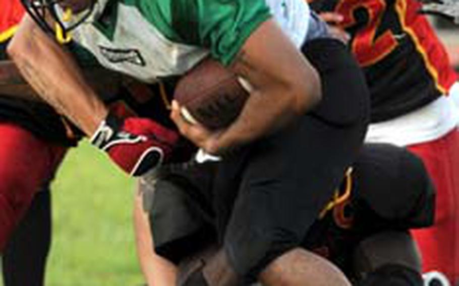 Kadena running back Eric Dagin looks for room to run against the Foster defense during Monday’s U.S. Forces Japan-American Football League game. Foster won 17-7 to clinch the Southern Division title.