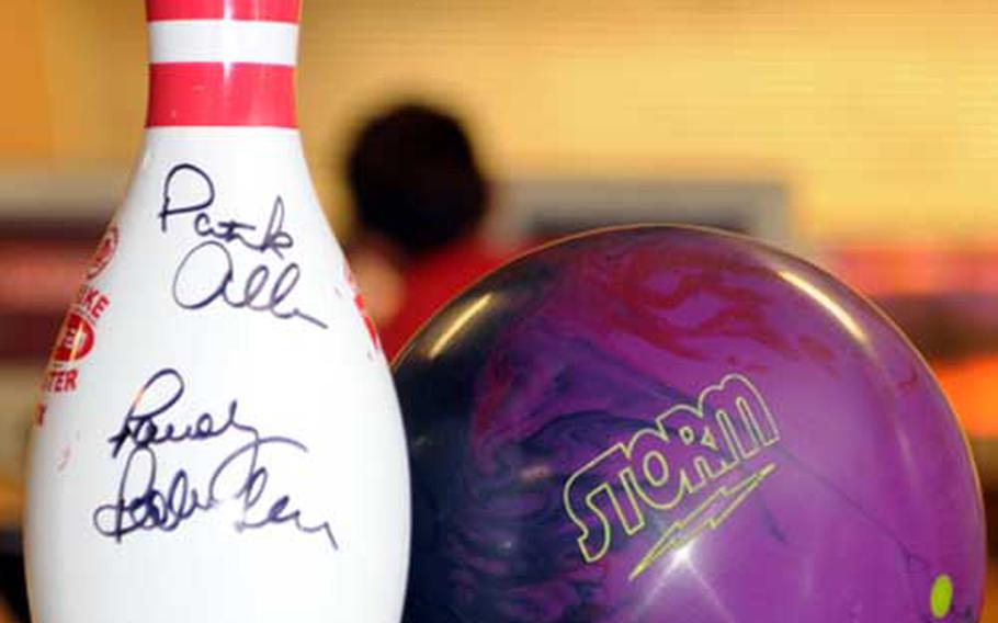 An autographed bowling pin and bowling ball adorn a table near the lanes during Friday&#39;s youth clinic at Emery Lanes, Kadena Air Base, Okinawa. The clinic was hosted by PBA pros Randy Pedersen and Patrick Allen.