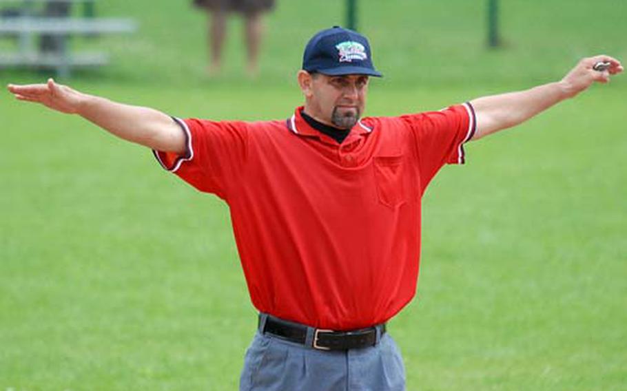 Umpire Joey Broxmeyer makes a call at second base during a game at the Softball European Regionals between KMC and Georgia. Broxmeyer paid his own way from the U.S. to umpire the tournament.