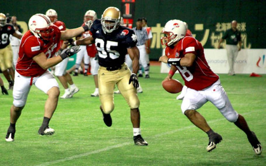 A player with the Japanese National Football Team rushes around the Fighting Irish defense during a game against Notre Dame alumni at Tokyo Dome on Saturday. The former Notre Dame players, who were billed as the Notre Dame Football Legends, won the game 19-3.