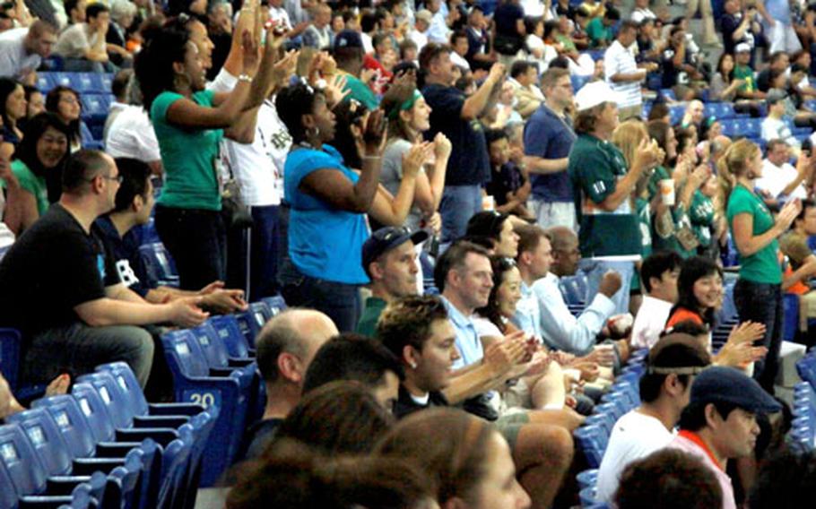 Notre Dame fans cheer at the Tokyo Dome as they watch former Fighting Irish legends face off against the Japanese National Football Team.