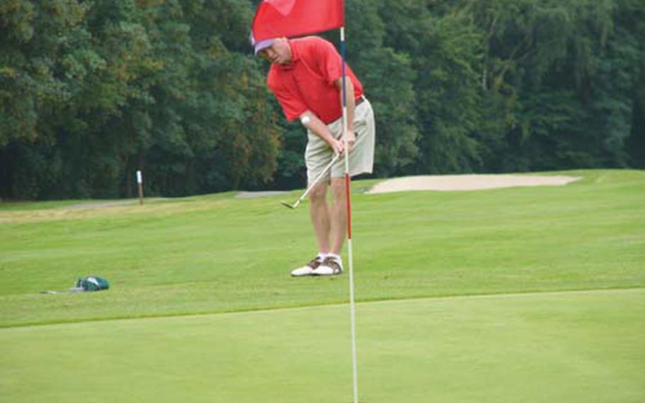 Navy golfer Tim McGrath of Heidelberg chips to within four feet of the flag on the ninth hole Sunday at Rheinblick golf course in Wiesbaden, Germany.