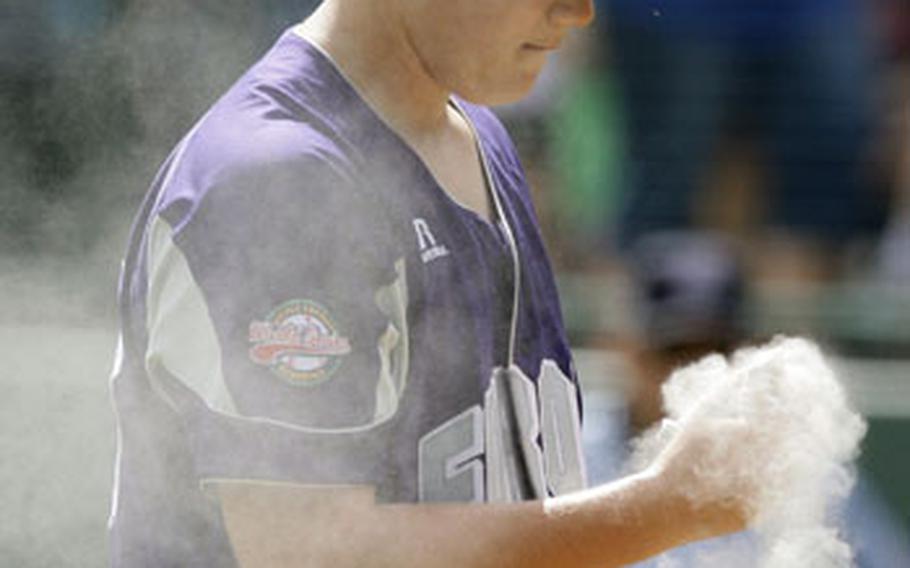 Ramstein AFB, Germany pitcher Cannon Byrd goes to the rosin bag after serving up a grand slam to Taoyuan, Taiwan&#39;s Yu Chieh Kao in the first inning.