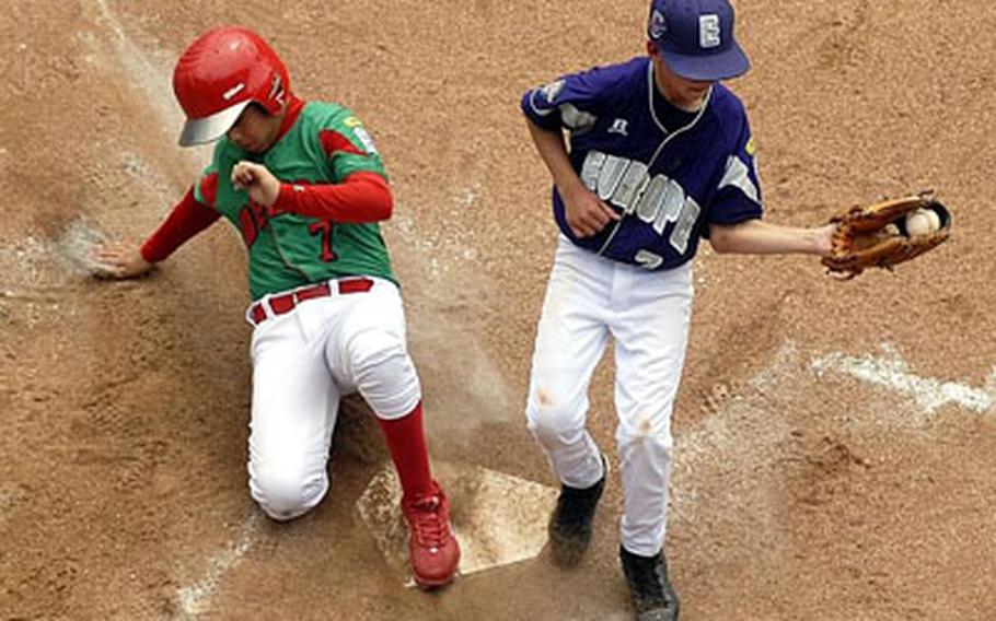 Reynosa, Mexico&#39;s Luis Trevino scores on a wild pitch as Ramstein AFB, Germany pitcher Chris Holba covers the plate in the fourth inning of Little League World Series baseball pool play.