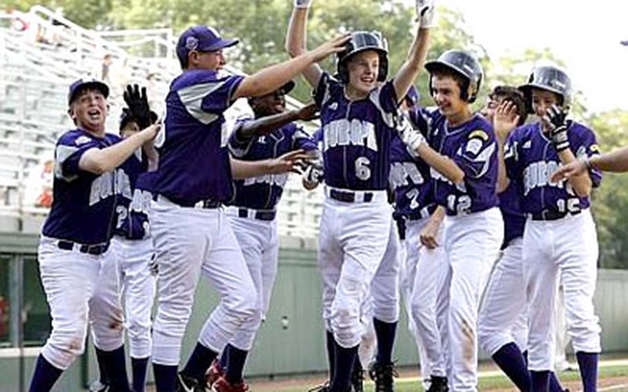 Matt Zembraski (6) of KMC celebrates with teammates as he crosses the plate after hitting a two-run home run in the fifth inning against Vancouver.