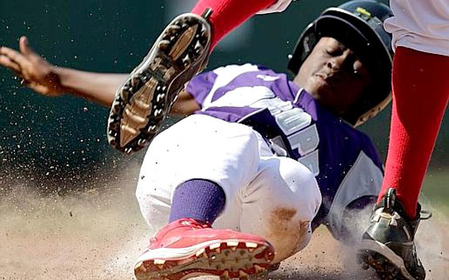 KMC&#39;s Santee Jackson slides past Vancouver, British Columbia, pitcher Anthony Cusati as he steals home on a wild pitch in the fifth inning..