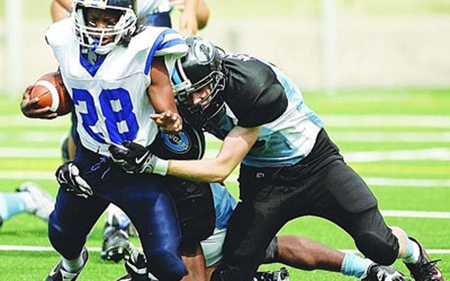 Seoul American running back Lionel Curry gets brought down by Osan’s Travis Neher during Saturday’s DODEA Korea season-opener. Osan won 12-0, its first victory over Seoul American since beating the Falcons 35-23 on Sept. 16, 2006.