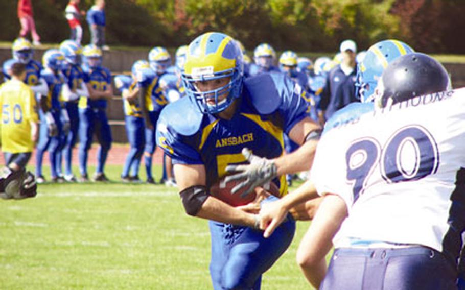 All-Europe senior Carter Gunn bursts past defender Michael Kotylar (90) of the Theodor-Fliedner-Gymnasium Typhoons for a successful two-point conversion run Saturday during Ansbach’s 45-6 victory.
