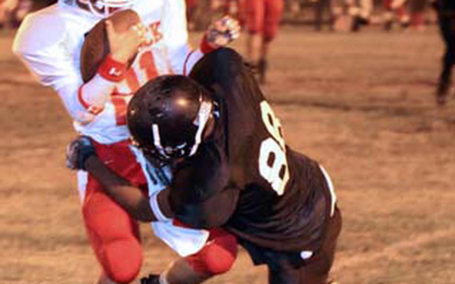 Kinnick receiver Francisco Quiocho is tackled by Zama’s Trey Fowler during Friday’s DODEA Japan/Kanto Plain Association of Secondary Schools football game at Naval Air Facility Atsugi, Japan. Zama rallied from a 19-6 first-quarter deficit to beat Kinnick 41-27.