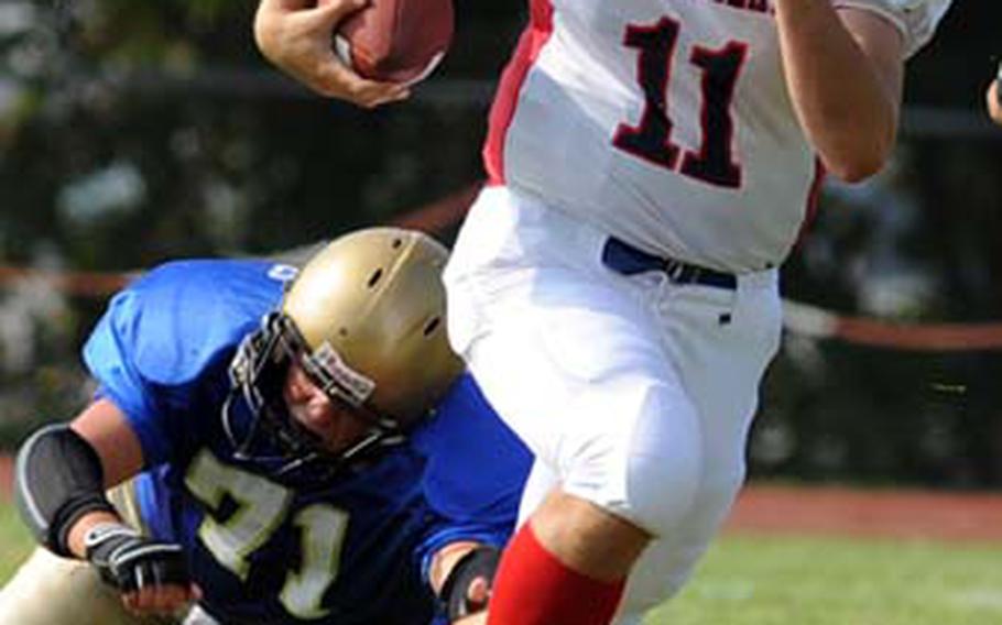 Lakenheath quarterback Alex Federinko rushes out of the reach of Wiesbaden&#39;s Daniel Hirschel-Weber.