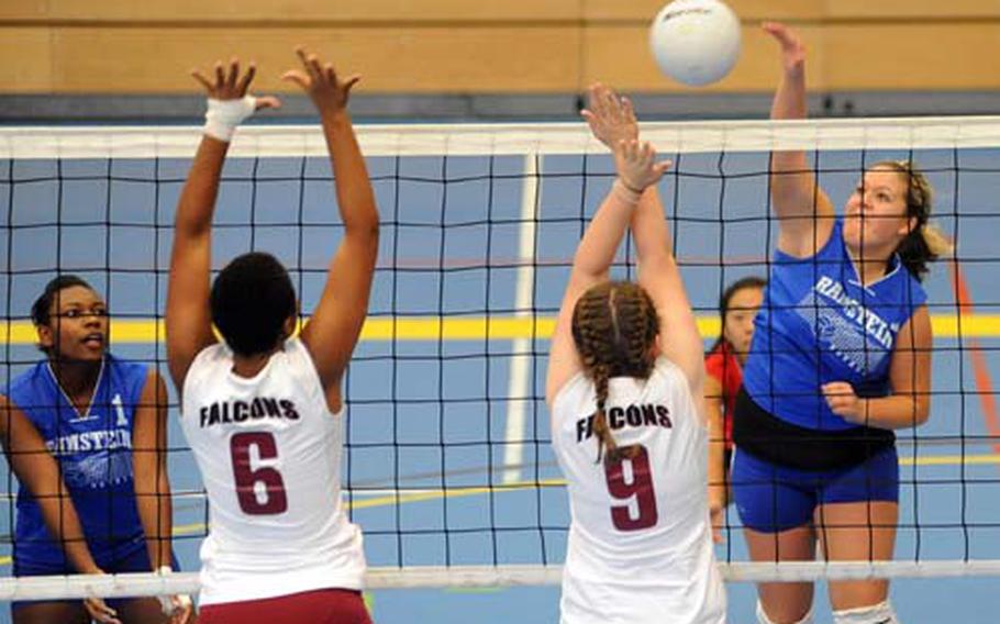 Ramstein&#39;s Charnel Austin, right, slams the ball over the net against Vilseck&#39;s Najja Beaulieu-Hains, left, and Taylor Hall as Ramstein&#39;s Chantel Barfield watches at far left.