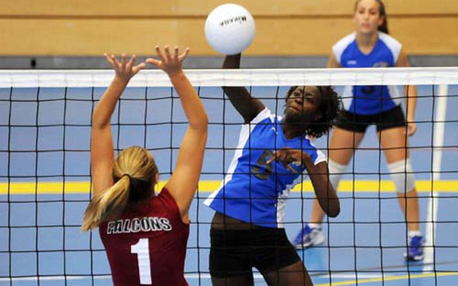 Tiffani Bunch of Ansbach, right, slams the ball over the net past Vilseck&#39;s Anna Muzzy in a DODDS-Europe volleyball match in Heidelberg that Vilseck won 25-8, 25-18, 25-21.