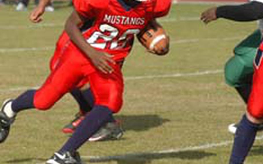 Menwith Hill running back Chris Jackson dashes up field for yardage during a 49-39 victory over the Alconbury Dragons. Jackson racked up 243 yards and three touchdowns on 18 carries.