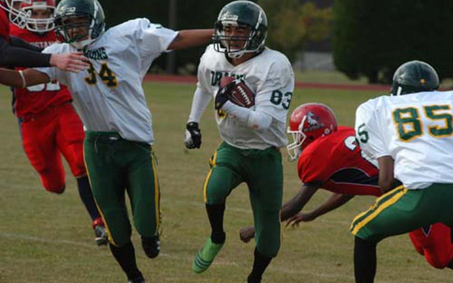 Alconbury running back Devin Pryor runs for big yardage as fullback Kerry Kuheana throws a block against the Menwith Hill Mustangs.