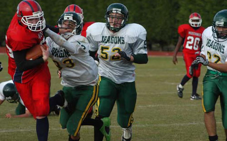 Menwith Hill wingback Andrew Breeding gives Alconbury defender Devin Pryor a stiff-arm to the face during the Menwith Hill Mustangs 49-39 victory at Alconbury.