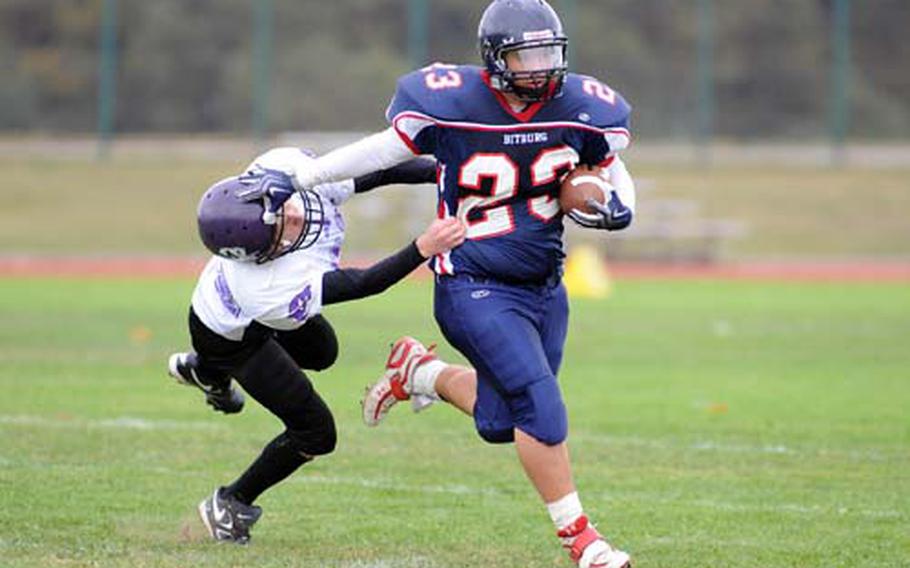 Bitburg&#39;s Adam Garcia, right, keeps Mannheim&#39;s Justin Sierkowski at arm&#39;s length as he rushes for a second-half TD in Bitburg&#39;s 35-0 win at home on Saturday.