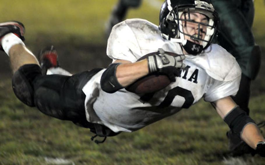 Zama American running back Ashton Norwood goes airborne for yards against Robert D. Edgren during Friday&#39;s game at Misawa Air Base, Japan. Zama won 12-7 and captured its first Far East Class A title-game berth.