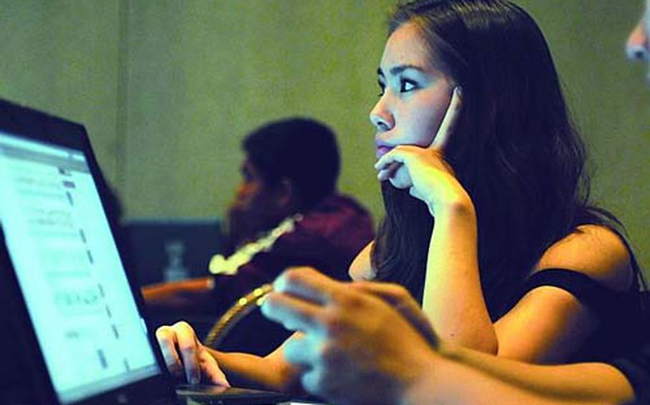 Osan American senior Nicole Sparks listens as Matthew C. Perry yearbook adviser Kevin Rossiter explains the parameters of the beginning photo and digital manipulation challenge Monday at the DODDS-Pacific Far East Journalism Conference at the New Sanno Hotel in downtown Tokyo. Sparks is an outside hitter for the two-time defending Far East Class A girls volleyball champions.