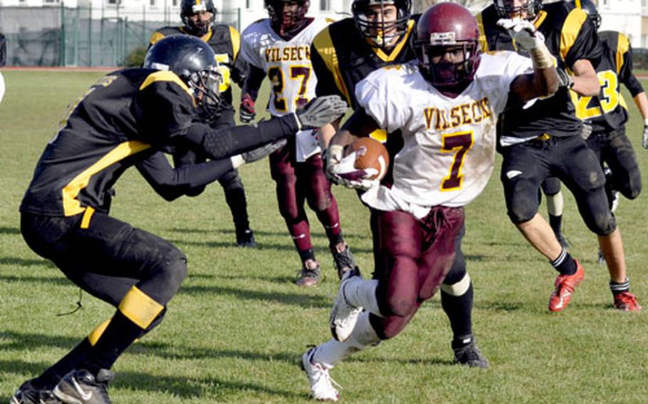 Vilseck running back Angelo Anderson jukes around a would-be Patch tackler during a 17-yard touchdown run during the Falcons&#39; 47-14 win. Anderson scored five touchdowns during the game, three in a 2½-minute stretch in the fourth quarter.